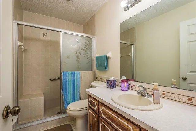 a bathroom with a sink toilet and shower