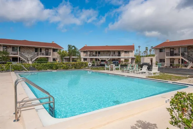 a view of swimming pool with outdoor seating and deck