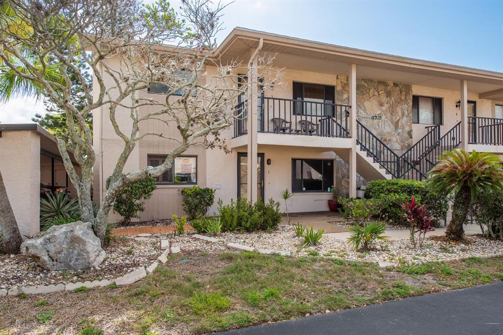 9910 Eagles Point Circle, Unit 3 Port Richey, FL 34668 - Photo 3 of 25 a front view of a house with garden