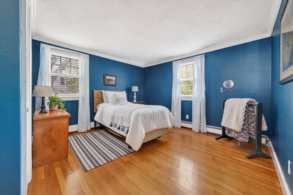 59 First Parish Road Norwell, MA 02061 - Photo 21 of 37 a bedroom with a bed and wooden floor