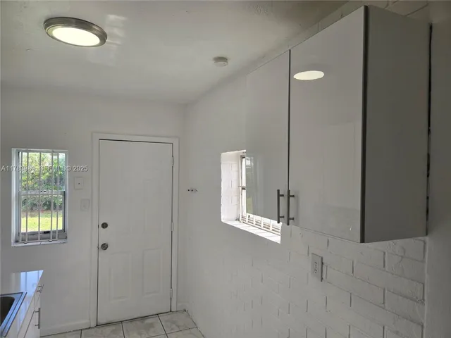 a kitchen with stainless steel appliances granite countertop a sink and a refrigerator