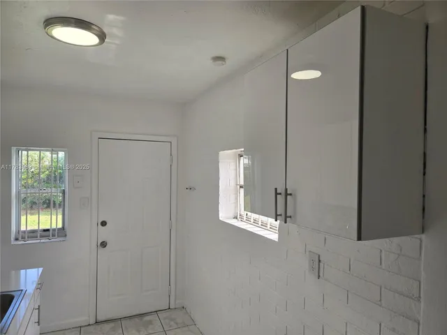 a kitchen with stainless steel appliances granite countertop a sink and a refrigerator