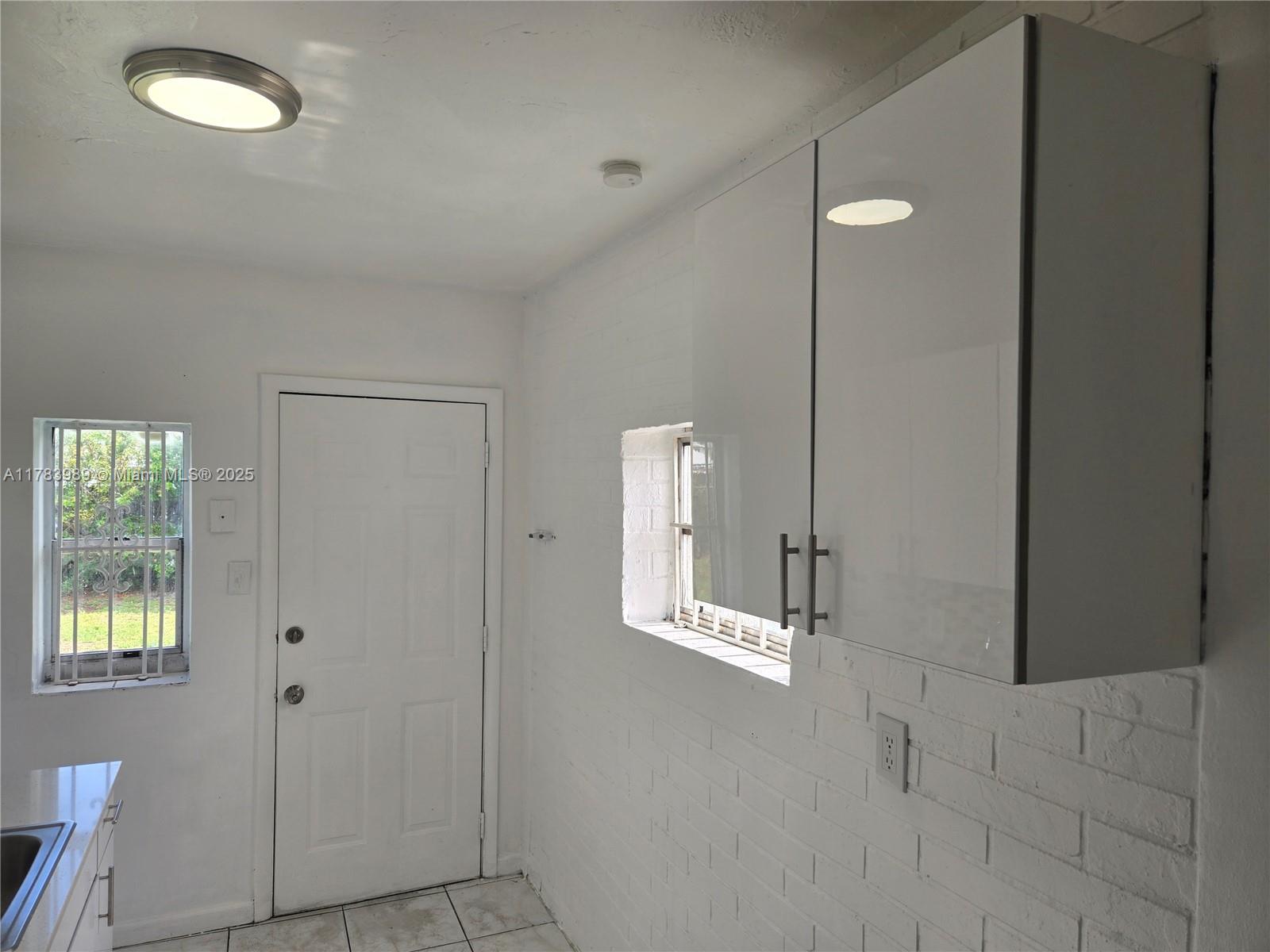 3310 Northwest 214th Street Miami Gardens, FL 33056 - Photo 11 of 17 an empty room with windows