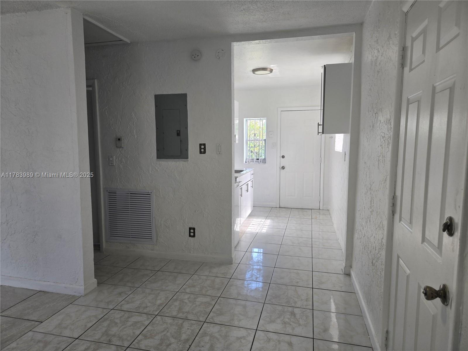3310 Northwest 214th Street Miami Gardens, FL 33056 - Photo 13 of 17 a view of a hallway
