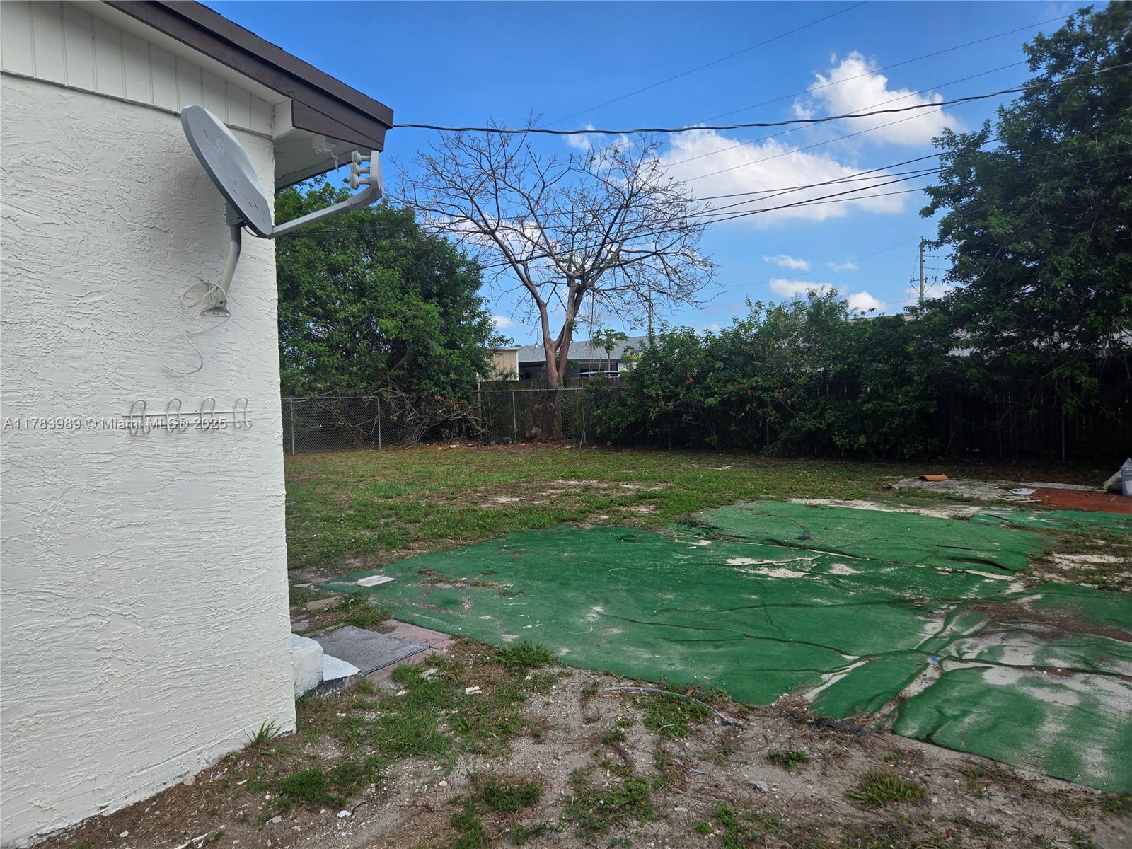 3310 Northwest 214th Street Miami Gardens, FL 33056 - Photo 15 of 17 a view of a backyard with large trees