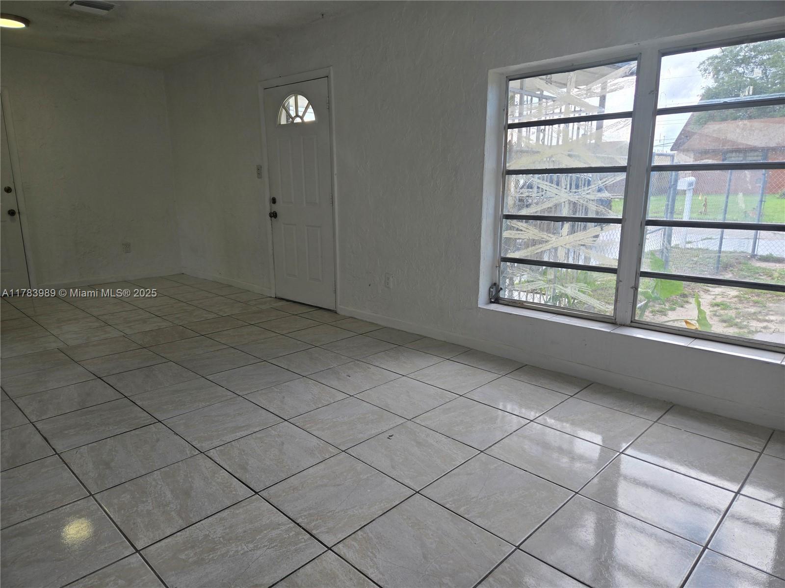3310 Northwest 214th Street Miami Gardens, FL 33056 - Photo 2 of 17 a view of an empty room and a window