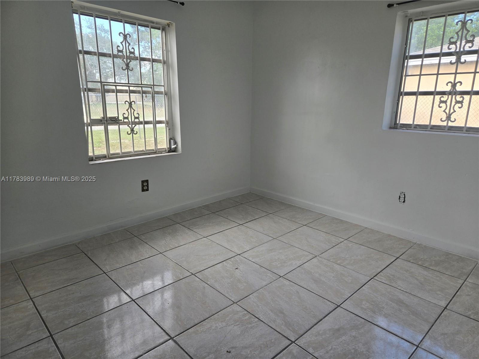3310 Northwest 214th Street Miami Gardens, FL 33056 - Photo 4 of 17 an empty room with windows