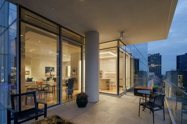 a kitchen with a table chairs stove and large window