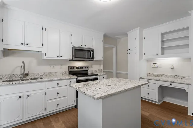 a kitchen with granite countertop cabinets stainless steel appliances and a sink