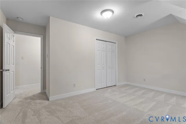 a white house that has a tree in the background