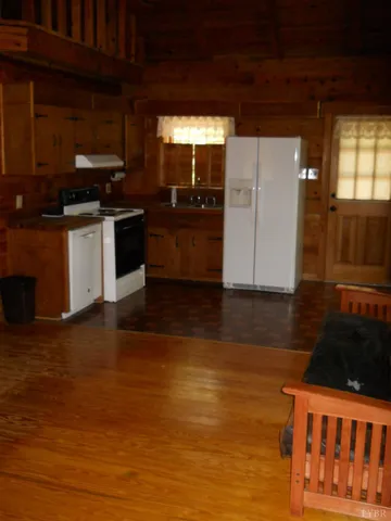 a kitchen with granite countertop a stove and cabinets