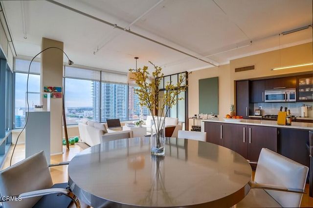 a dining room with furniture window and wooden floor