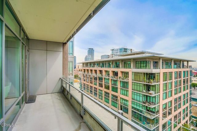 a view of balcony with a large window and stairs