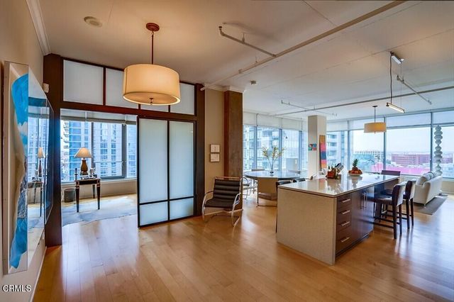 a view of a dining room with furniture window and wooden floor