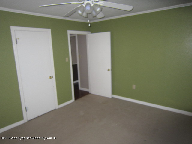 4114 Parker Street Amarillo, TX 79110 - Photo 4 of 15 a view of an empty room with a fan