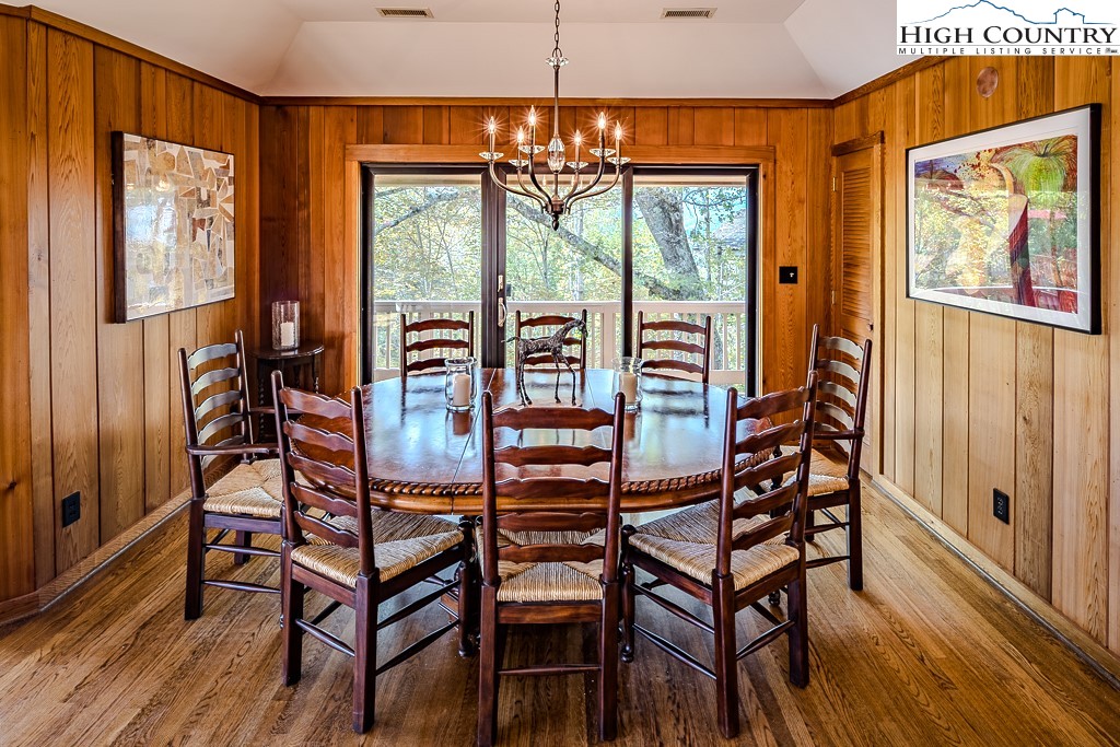 233 Balsam Road Boone, NC 28607 - Photo 20 of 50 a view of a dining room with furniture a chandelier and wooden floor