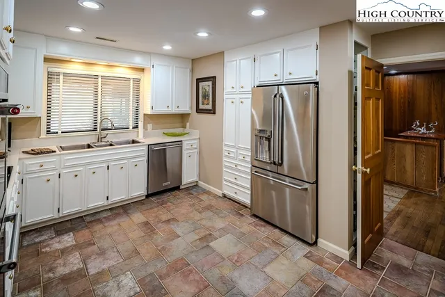 a kitchen with a stove sink and cabinets