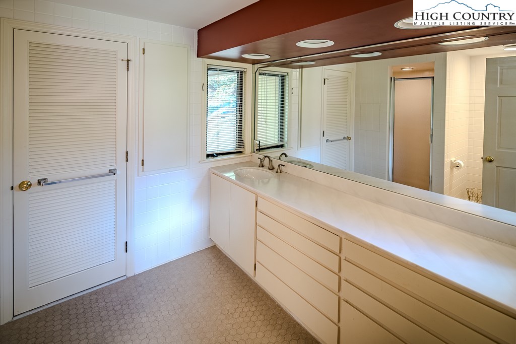 233 Balsam Road Boone, NC 28607 - Photo 29 of 50 a bathroom with a sink and a mirror
