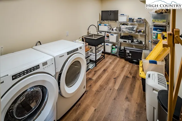 a spacious bedroom with a bed a couch and dresser next to a window