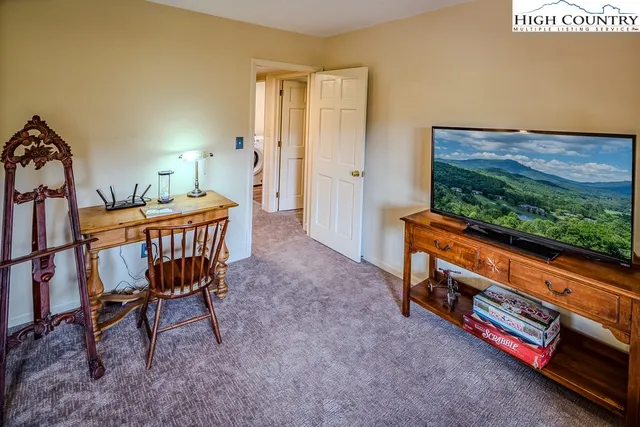 a view of a hallway view with two couch and a dining table