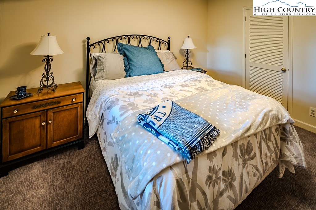 233 Balsam Road Boone, NC 28607 - Photo 41 of 50 a bedroom with a bed and dresser with mirror