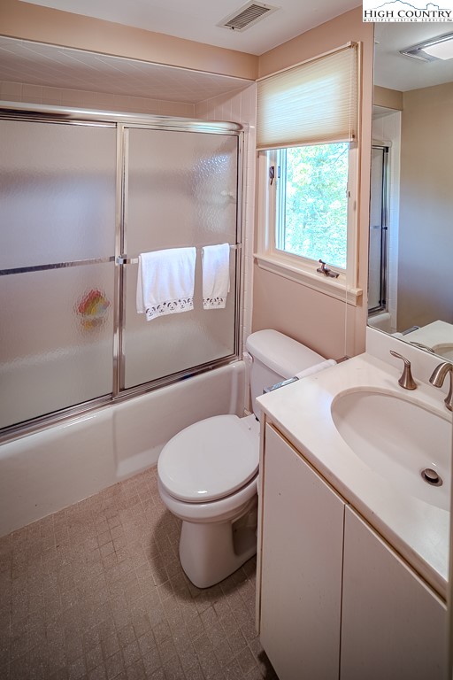 233 Balsam Road Boone, NC 28607 - Photo 42 of 50 a bathroom with a sink toilet and window