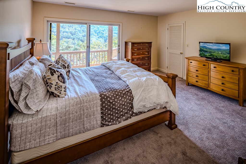 233 Balsam Road Boone, NC 28607 - Photo 43 of 50 a bed sitting in a bedroom next to a window