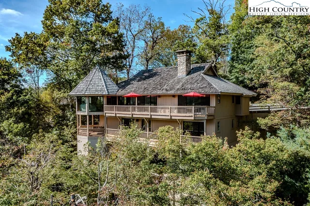 a aerial view of a house with large trees and plants