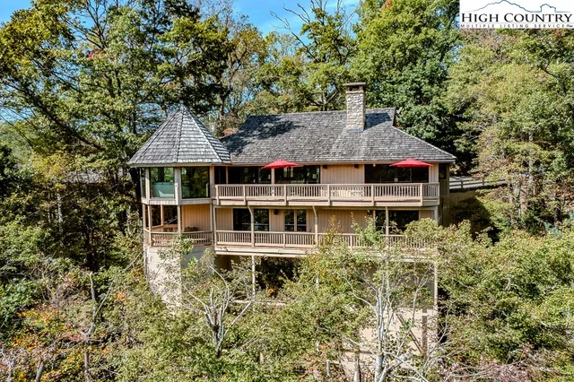 a aerial view of a house with a yard and balcony