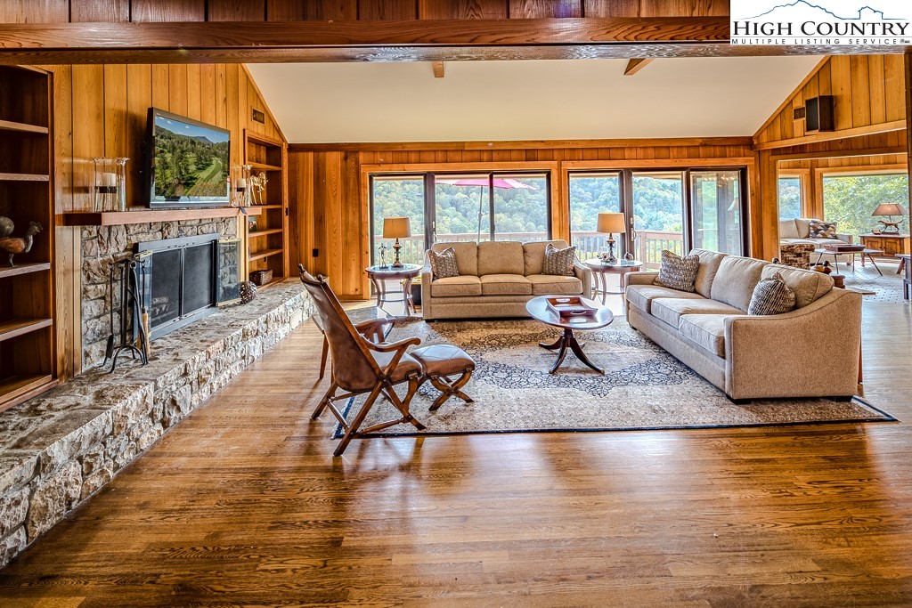233 Balsam Road Boone, NC 28607 - Photo 6 of 50 a living room with fireplace furniture and a floor to ceiling window