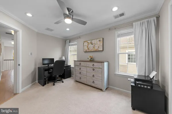 a view of workspace with furniture and a window