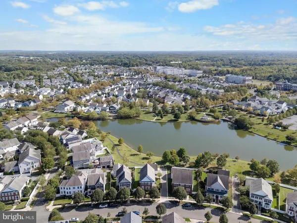 an aerial view of a city with lots of residential buildings lake and ocean view