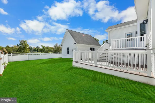 a view of a house with a yard and sitting area