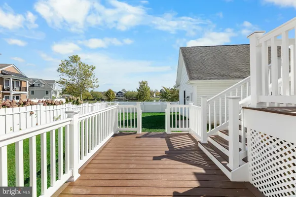 a view of a deck with wooden floor and fence