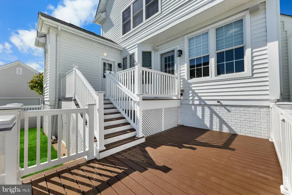 a view of a house with wooden deck