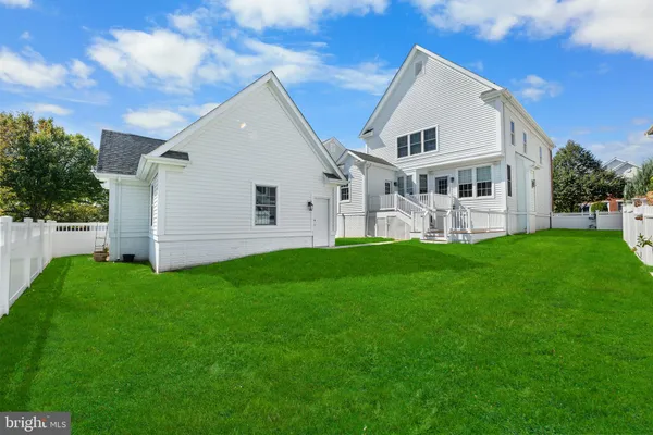 a front view of house with a garden and yard