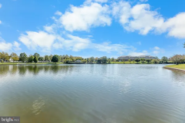 a view of a lake with houses in the back