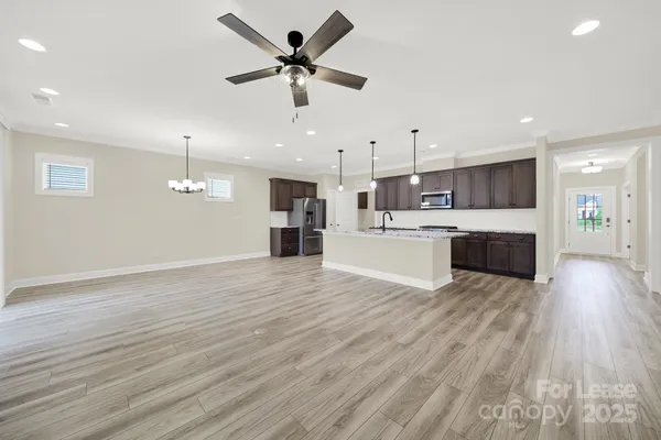 a view of kitchen with cabinets and wooden floor