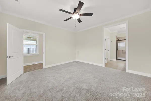 a view of an empty room and a ceiling fan