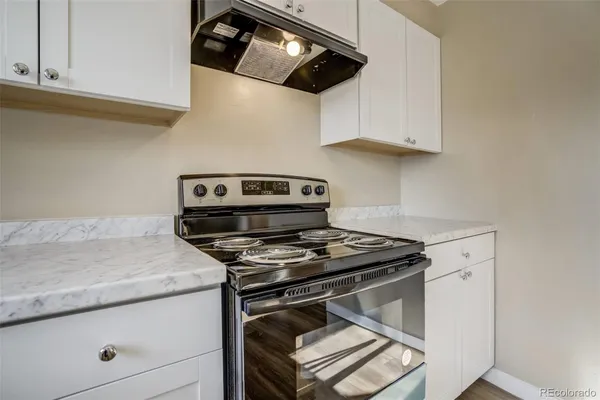 a stove top oven sitting inside of a kitchen