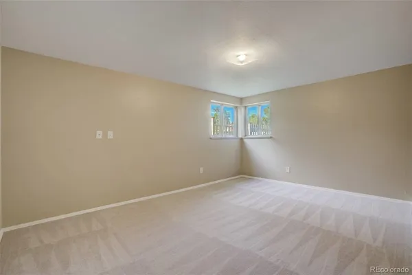 a view of an empty room with windows