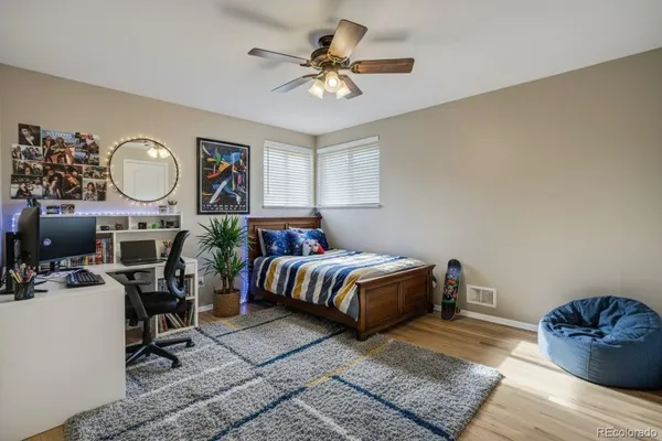 a bedroom with bed and a chandelier
