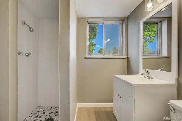 a bathroom with a sink a vanity and a window