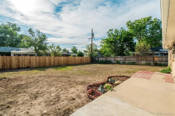 a view of a backyard with wooden fence