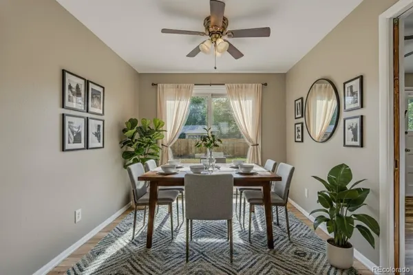 a dining room with furniture a window and a chandelier