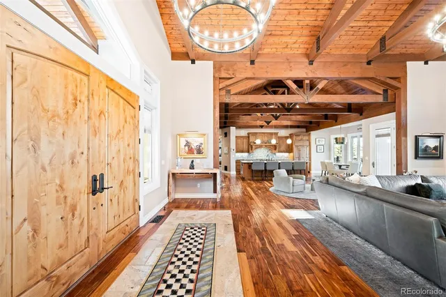 a living room with furniture a flat screen tv and a large window