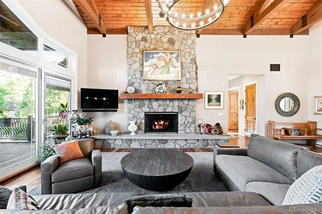 a living room with furniture a fireplace and a large window