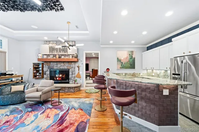 a living room with furniture a flat screen tv and a floor to ceiling window
