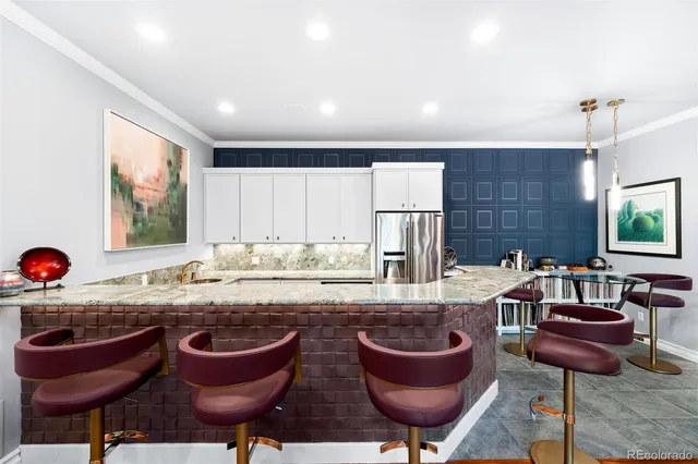 a kitchen with a table chairs and a view of living room
