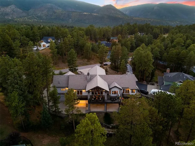 an aerial view of a house with garden space and street view